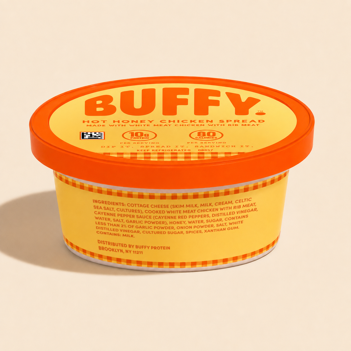 A tub of BUFFY. Hot Honey Chicken Spread showing the ingredients list on a warm cream background.